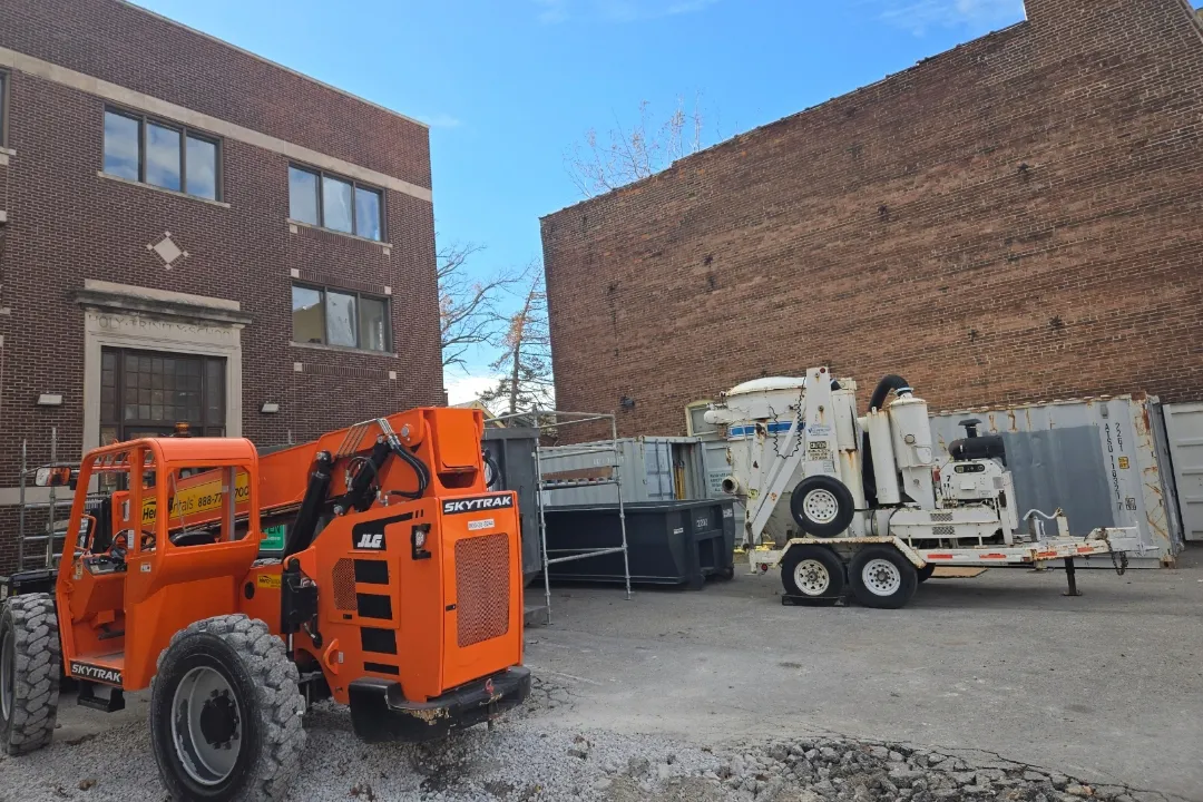 AES lift and equipment at a brick building job site